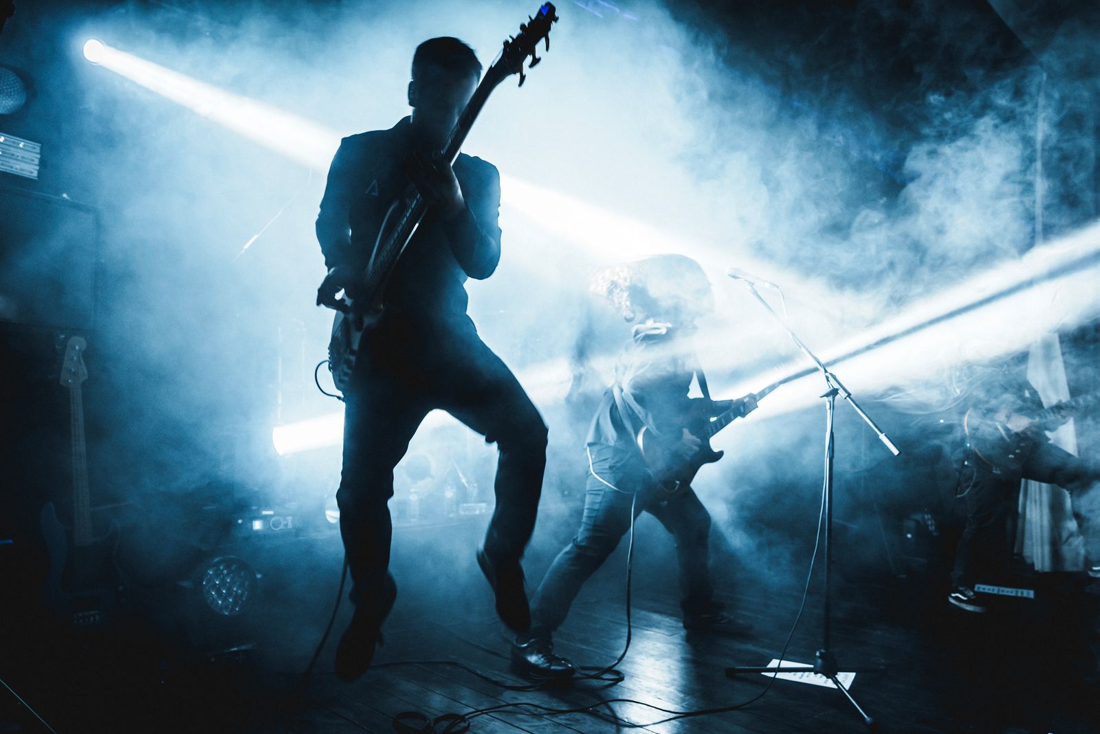 Apotheus performing live under blue stage lights