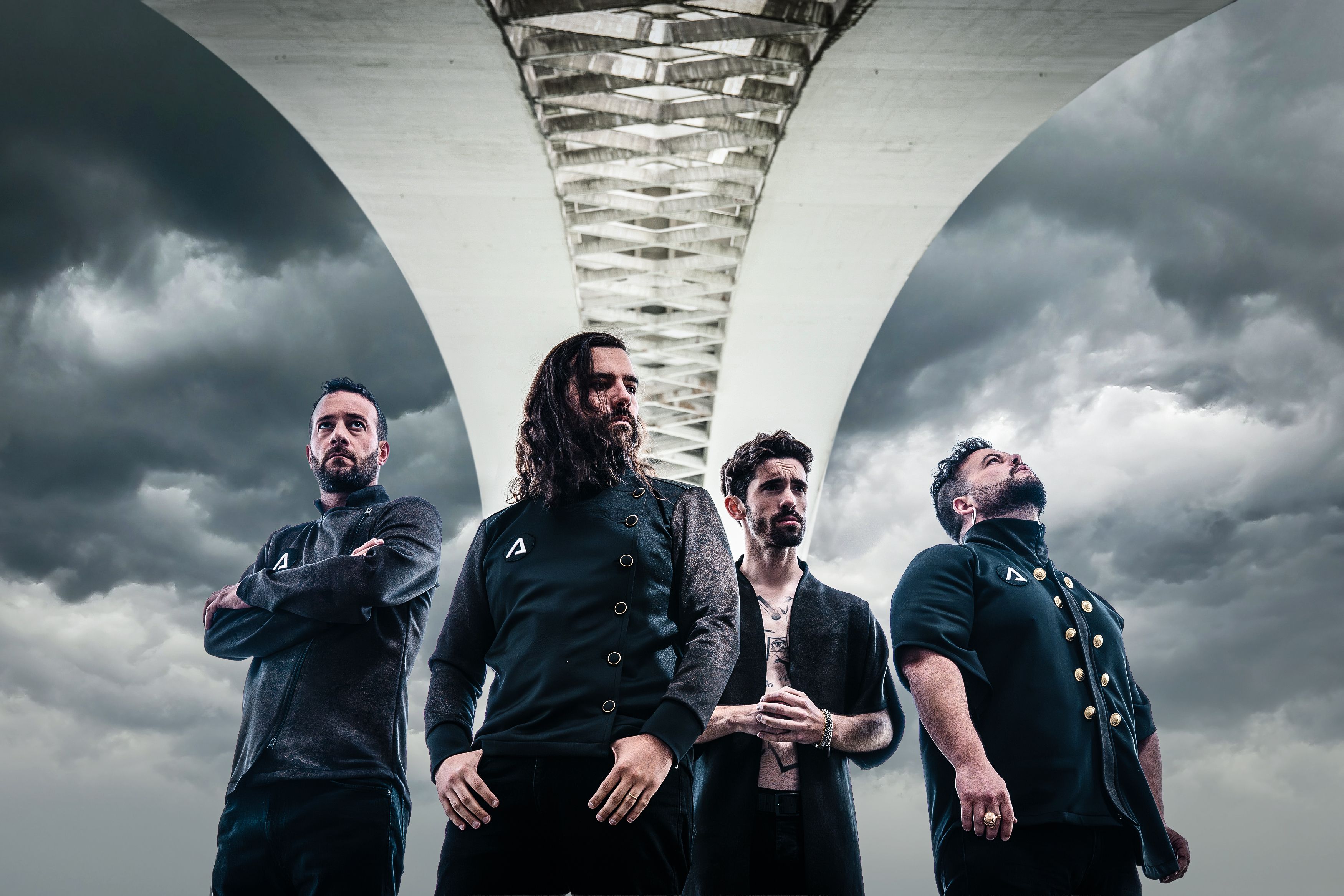 The four members of Apotheus standing beneath a concrete bridge.